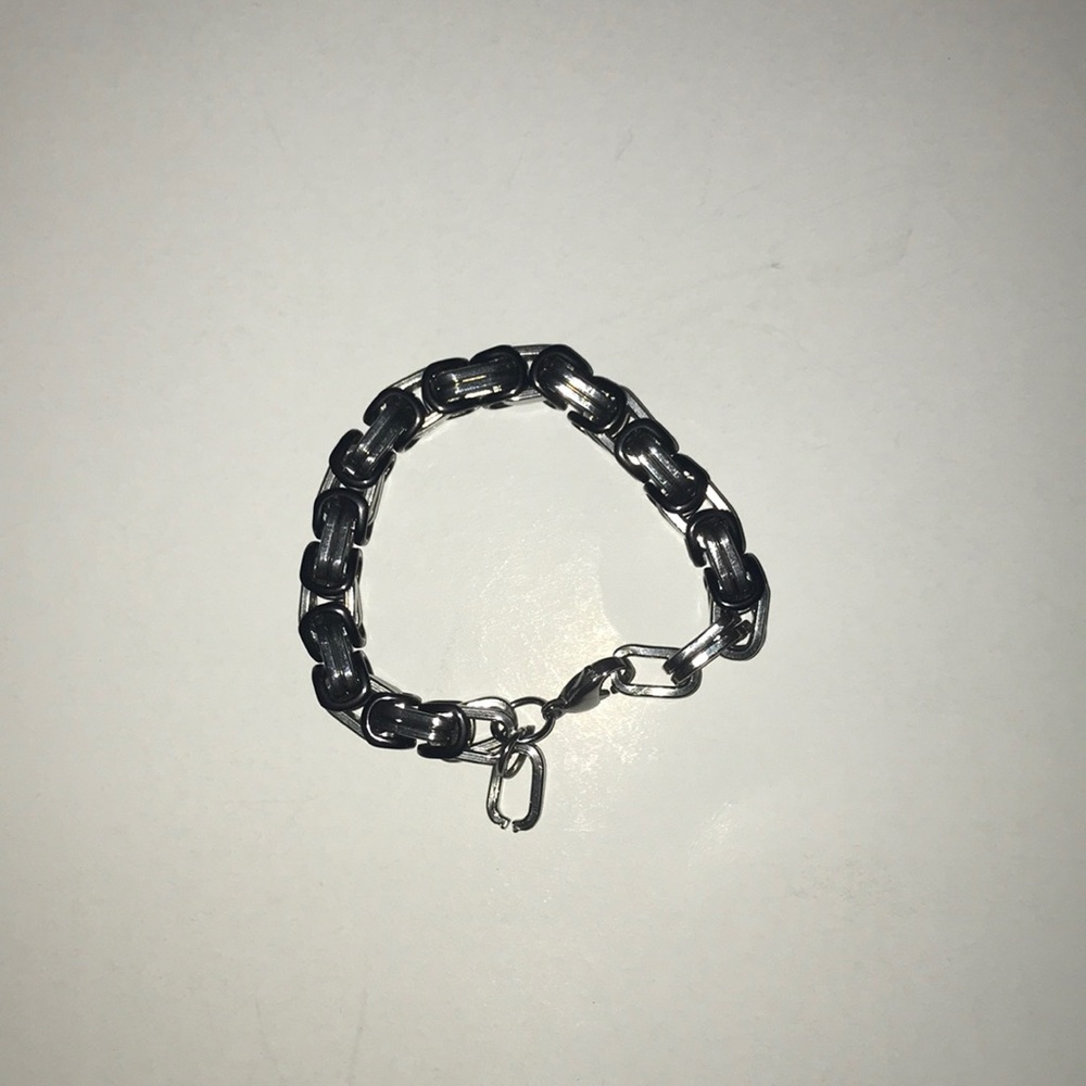Small stainless steel bracelet with black links.